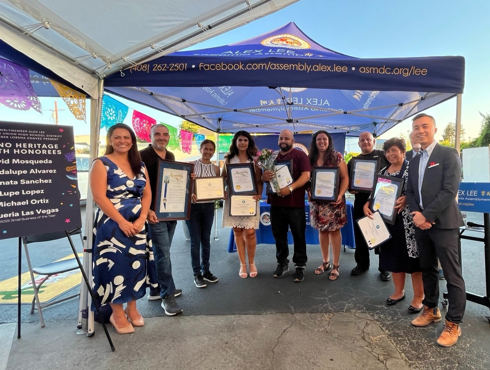 Standing with honorees holding awards