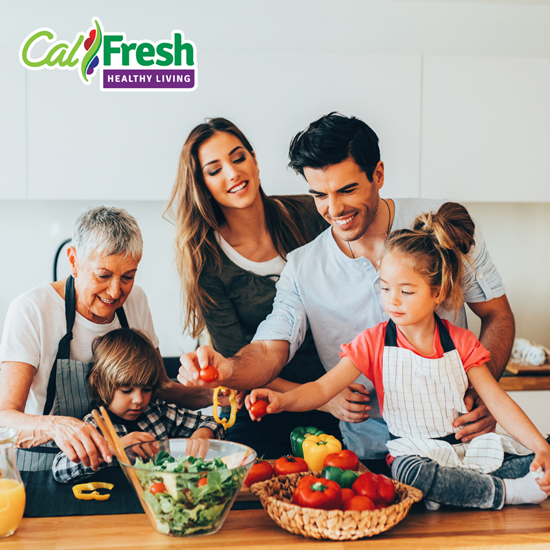 Multi-generational family in kitchen preparing food