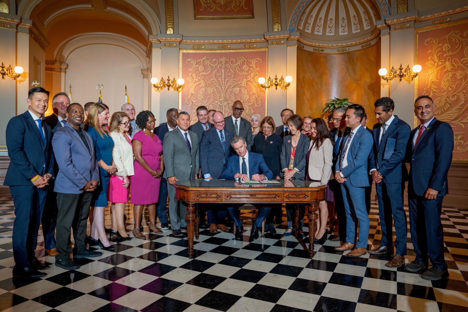 The Governor signs ABX2-1 at Rotunda of the State Capitol