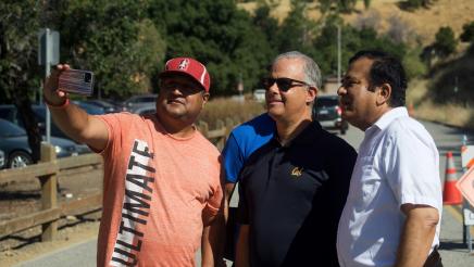 San Jose Councilmember David Cohen poses for a selfie with participants of the Community Walk and Talk event.