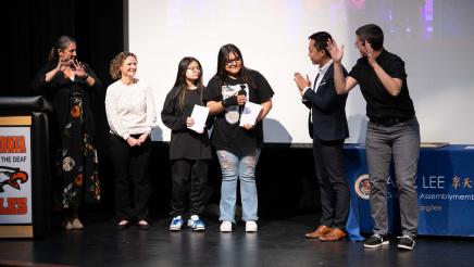Asm. Lee with students and interpreters on stage