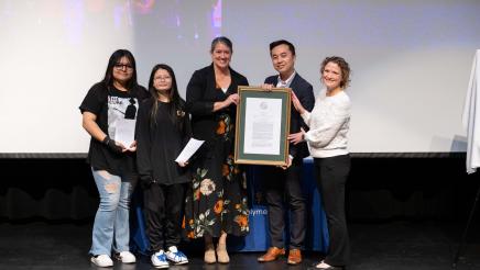 Asm. Lee with attendees presenting the official plaque for AB 2367