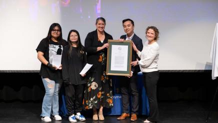 Asm. Lee with attendees presenting the official plaque for AB 2367